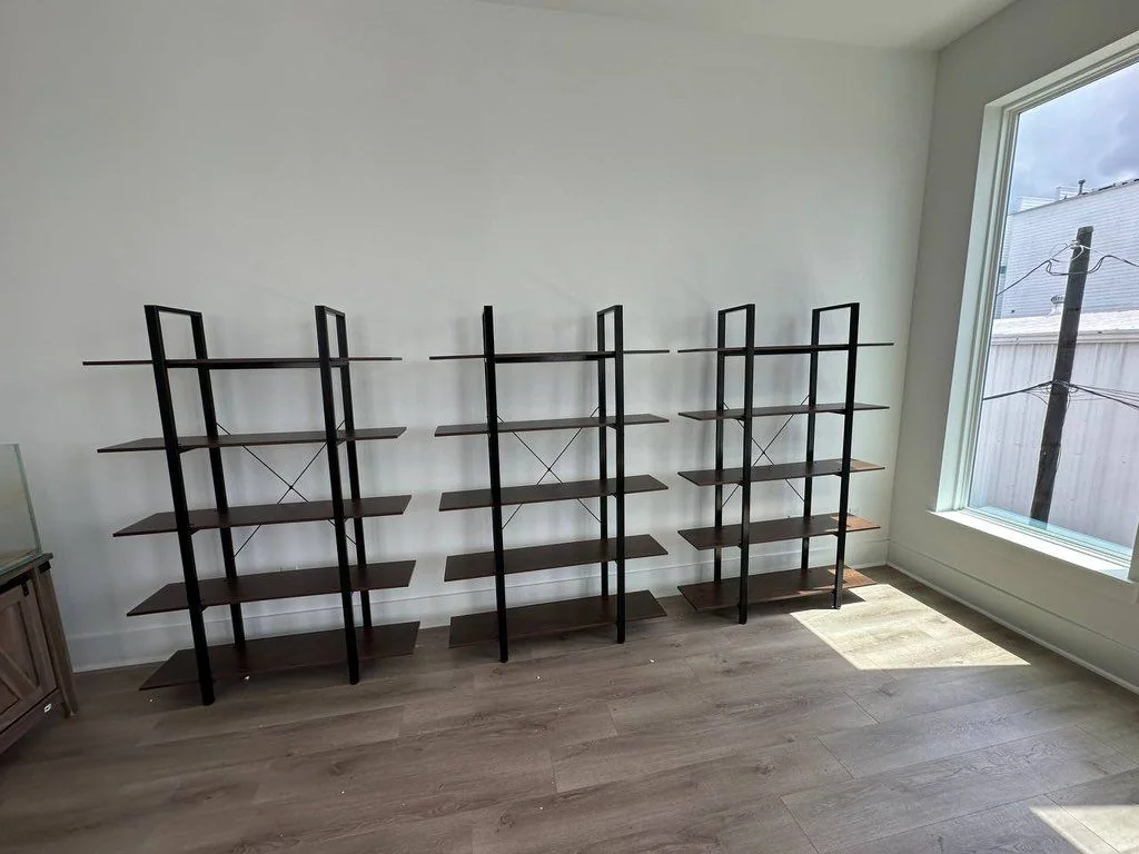 Three assembled storage shelves standing side by side