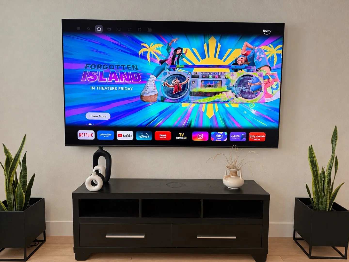Wall-mounted television above a black console in a living room